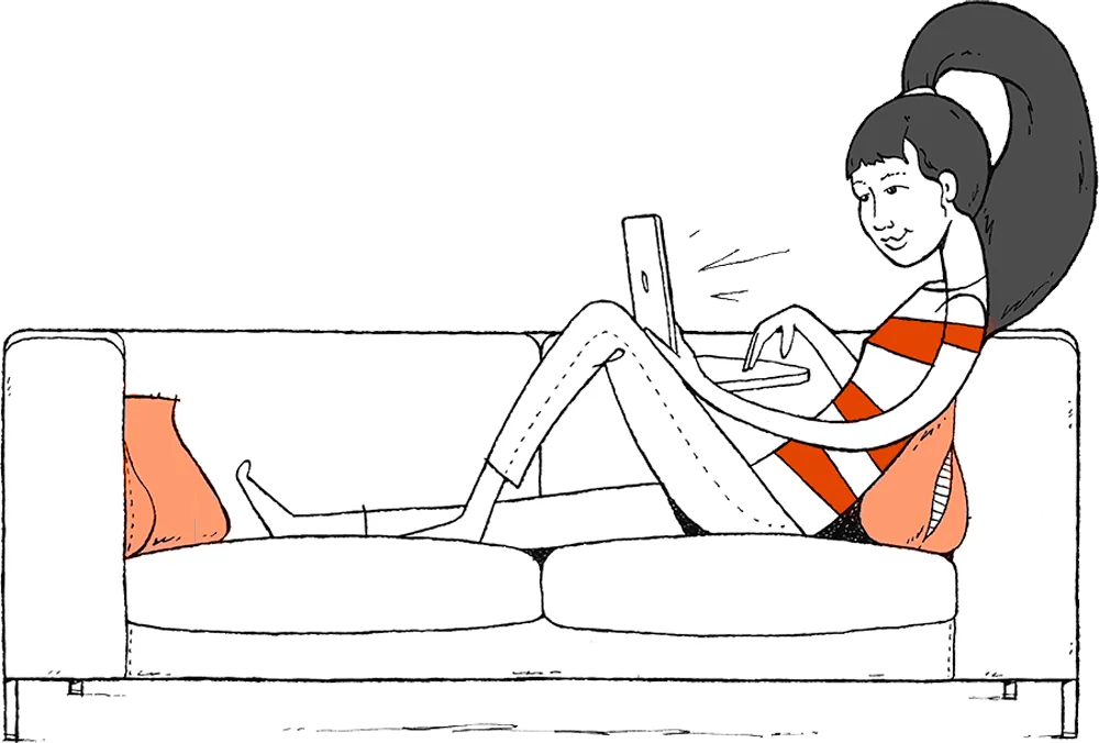 A woman relaxing on a sofa with her laptop